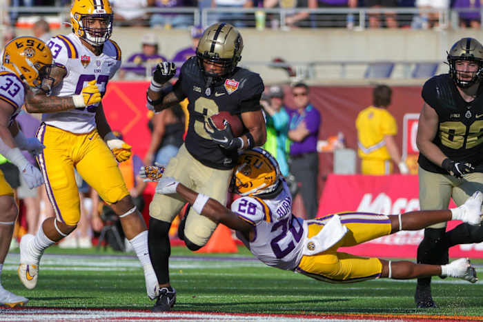Purdue Boilermakers wide receiver Tyrone Tracy (3) avoids a tackle by LSU Tigers safety Major Burns (28) during the second half at Camping World Stadium.